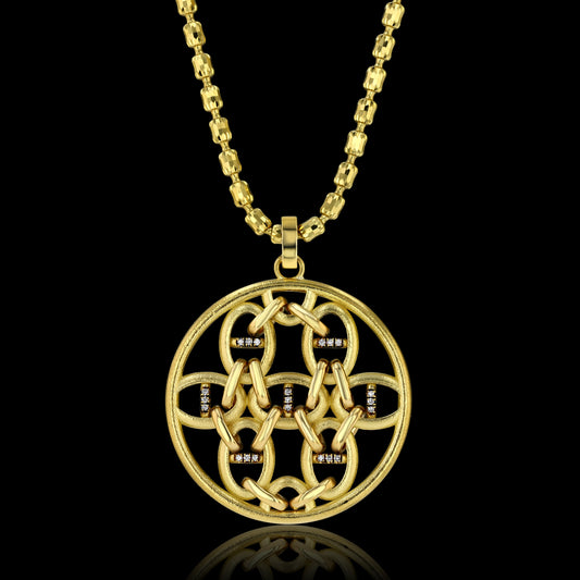 Round pendant, with geometrically placed horse bit shapes encrusted with diamonds on one side and rubies on the other, on an 18k yellow gold necklace.